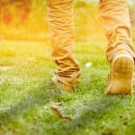 40010489 - a walk towards brighter future, a beautiful shot of feet walking towards sunlight or going ahead towads sunrise or sunset on the grass or park or field running or morning walk or workout, tone added